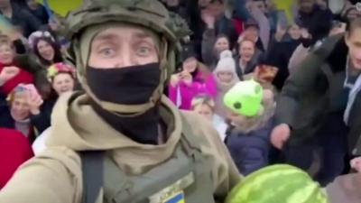 Soldier holding a watermelon in a crowd