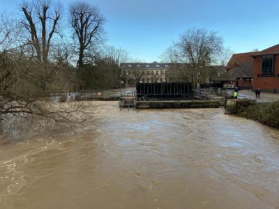 Floodwater overwhelming a weir in Chippenham.