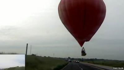 Hot air balloon close to road
