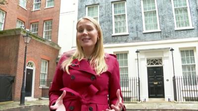 Shelley Phelps standing in front of the black door at 10 downing street