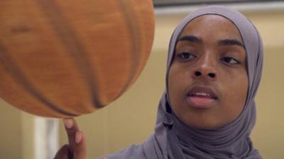 Bilquis Abdul-Qaadir spinning a basketball