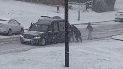 The hearse being pushed