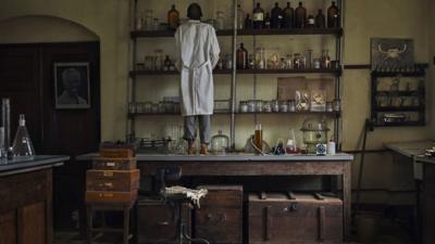 Lab caretaker looks at shelves