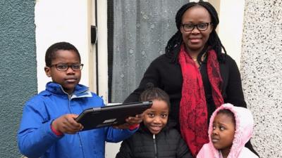 The Ogu family with their new laptop