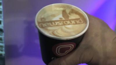 Drink of coffee with Newsround logo printed on top