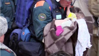 Rescuer carries out the baby pulled alive from the rubble of the apartment block in Magnitogorsk, Russia, 1 January 2019