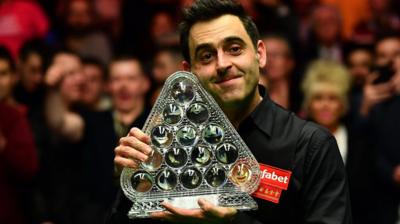 Ronnie O'Sullivan celebrates with Masters trophy