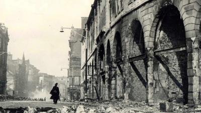 A street in Swansea strewn with rubble after Blitz bombing