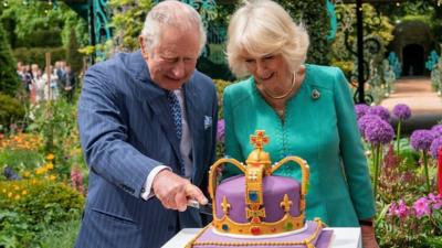 King Charles and Queen Camilla cut a crown-shaped cake in Newtownabbey