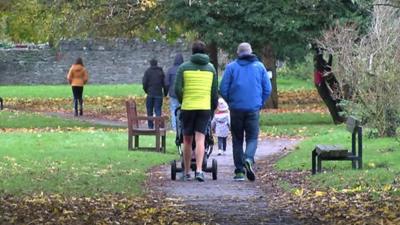 People walking through a park