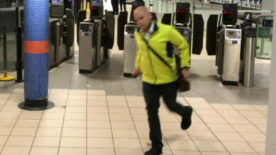 A member of the public runs for the last Tube at Euston Station