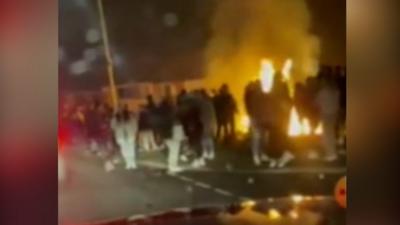 People gathered around a bonfire in the Gurnos estate in Merthyr Tydfil