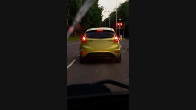 Car with its driver allegedly watching football