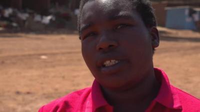 Woman in red shirt in rural Zimbabwe