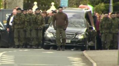 Men in paramilitary-style uniforms attended Michael Barr's funeral