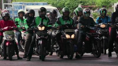 Motorcycle taxis in a row in Jakarta