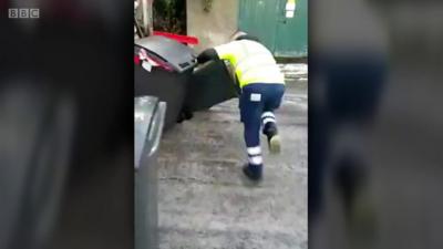 Bin man falls over on the ice