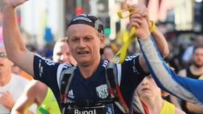 Blind Dave crosses a marathon finish line