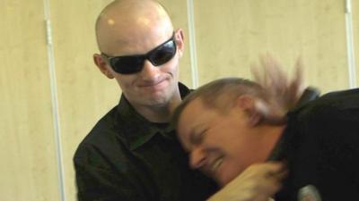 David Black practising how to use his white cane against an attacker