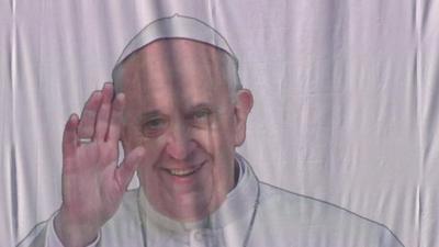 Pope Francis image on a banner
