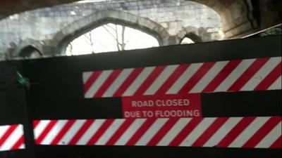 Water close to top of a flood gate which protects York