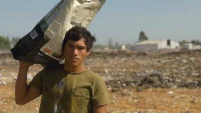 Boy at rubbish dump