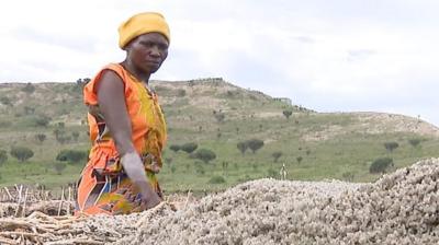 Woman looking at salt pile