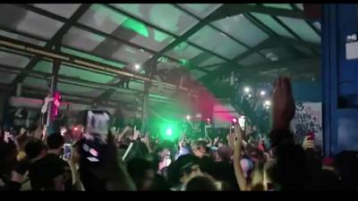 Hundreds of people are dancing and filming themselves on their phones in a warehouse in Yate.