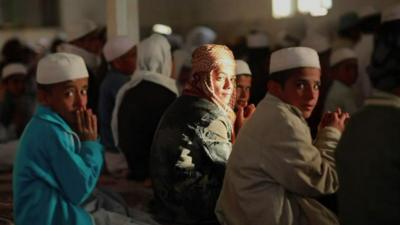 Boys praying in Iran