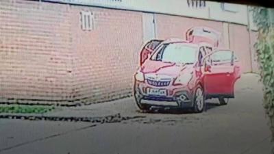 Car with doors open at car wash