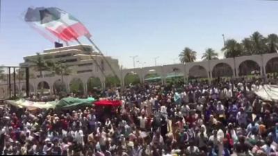 Crowds of people gather outside the army's headquarters in Khartoum