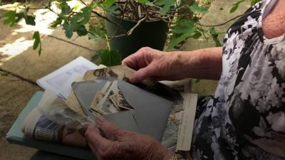 Audrey Phillips looks through her husband's paperwork