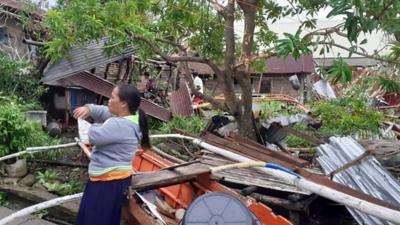 Residents survey damage from Typhoon Phanfone in Biliran, Philippines