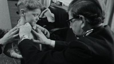 A GP tends to a patient in 1965