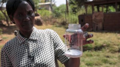 Woman holding a container with salt inside