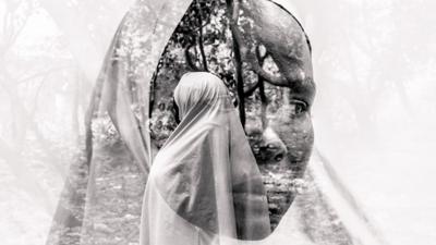 Black and whit portrait of a Nigerian woman wearing a veil