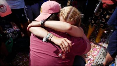 Newly-engaged couple hug at Glastonbury