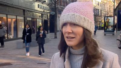 Shopper outside Debenhams in Leeds