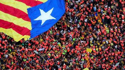 Aerial shot of protesters holding Catalonia's flag