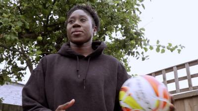 Football player holding football