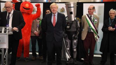 Boris Johnson next to a man in an Elmo suit