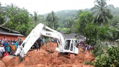 Sri Lankan military rescue workers search for survivors at the site of a mudslide in Bellana village in Kalutara on May 26, 2017