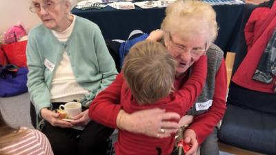 Henry, aged three, handed out presents at the party