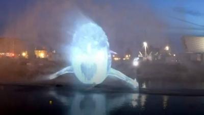 A whale appears as a visual experience on Liverpool Docks for a light show