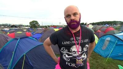 Man at Glastonbury talking