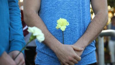 Kids are handed flowers as they go back to school