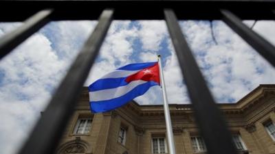 The Cuban national flag is seen raised over their newly reopened embassy in Washington