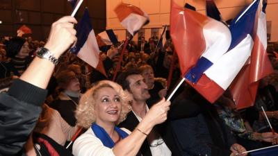 Front National supporters wave flags