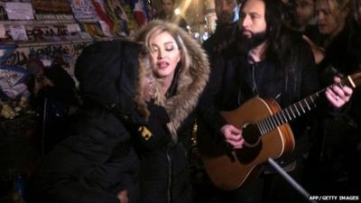 Madonna (C) sings next to her guitarist Monte Pittman (C-R) and her adoptive son David Banda