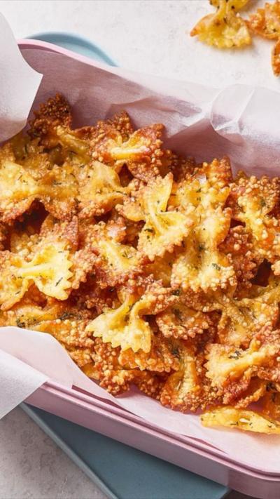 A pile of crispy pasta bows in a pink dish